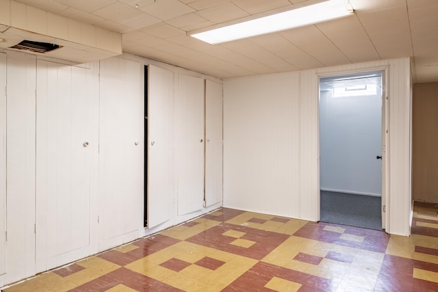 finished basement with tile patterned floors