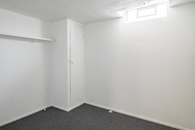 basement featuring dark colored carpet