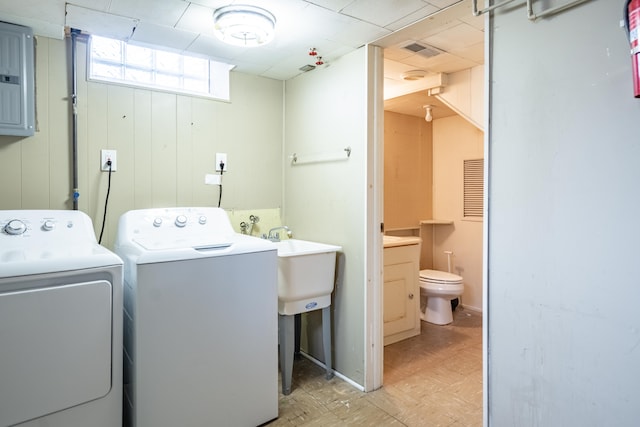 washroom with laundry area, visible vents, electric panel, light floors, and washer and clothes dryer