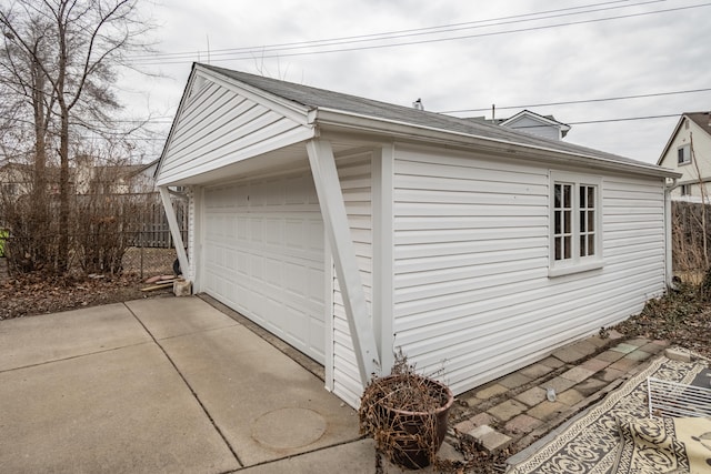 detached garage featuring fence