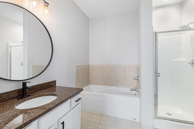 bathroom with a stall shower, vanity, a bath, and tile patterned floors