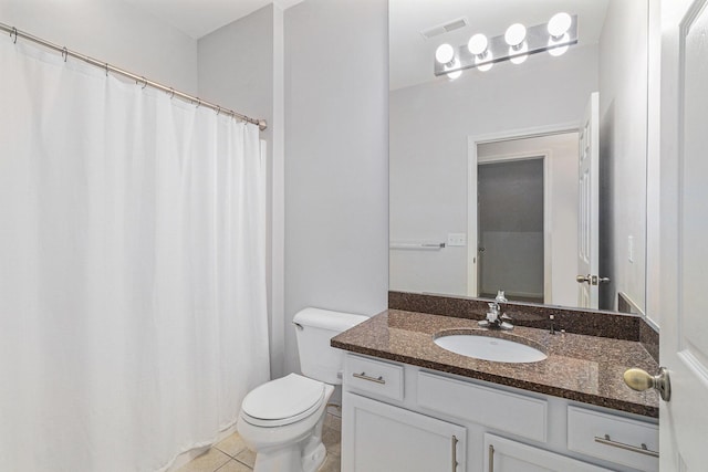 bathroom with toilet, vanity, tile patterned flooring, and visible vents