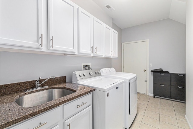 clothes washing area with cabinet space, visible vents, washer and dryer, a sink, and light tile patterned flooring