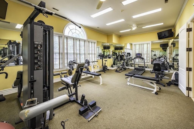 workout area featuring crown molding, visible vents, and ceiling fan