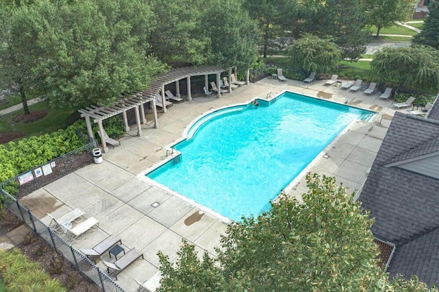 community pool with a patio area, fence, and a pergola