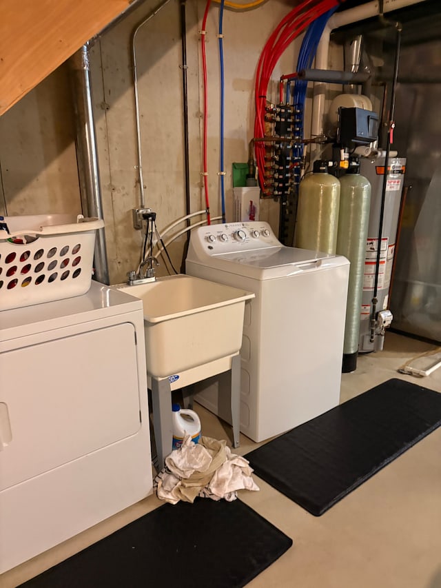 washroom with water heater and washer and dryer