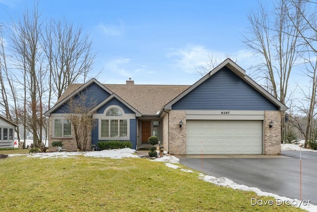 single story home featuring brick siding, a chimney, a garage, driveway, and a front lawn