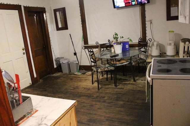 kitchen with dark wood finished floors and electric range