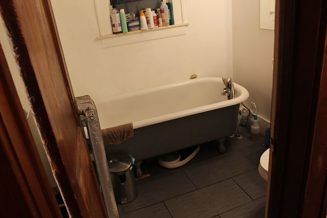 full bathroom with a freestanding bath and toilet