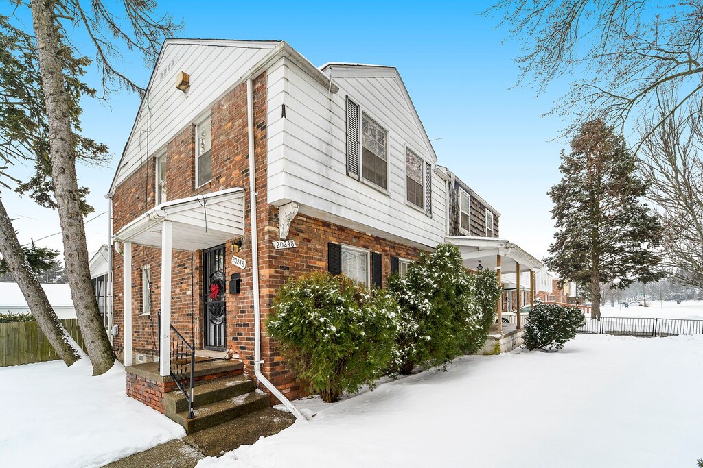 20248 Regent Dr, Detroit, MI 48205 - view of front facade with fence and brick siding