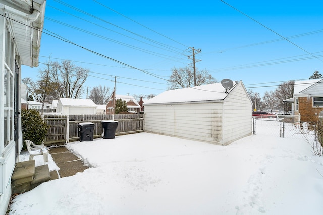 20248 Regent Dr, Detroit, MI 48205 - yard covered in snow with an outbuilding and fence