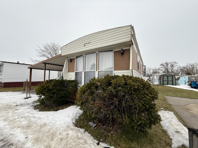 view of home's exterior with a shed and an outdoor structure