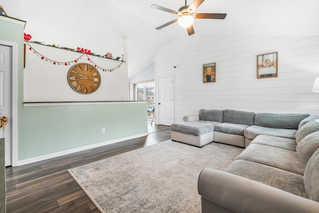 living area featuring ceiling fan, lofted ceiling, wooden walls, dark wood-type flooring, and baseboards