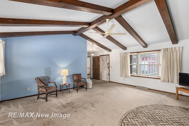 sitting room with carpet floors, vaulted ceiling with beams, and baseboards