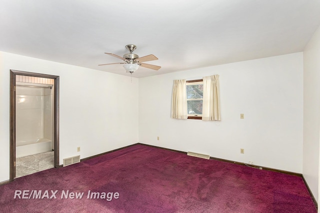 carpeted empty room featuring baseboards, visible vents, and a ceiling fan