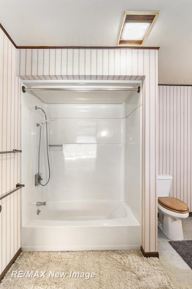 bathroom featuring toilet, wallpapered walls, bathtub / shower combination, and visible vents