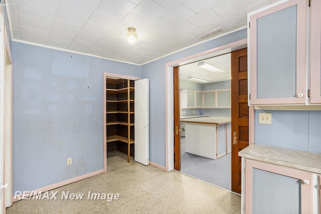 interior space featuring baseboards and light speckled floor