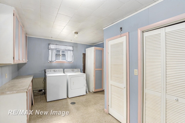 laundry area featuring washing machine and dryer and cabinet space