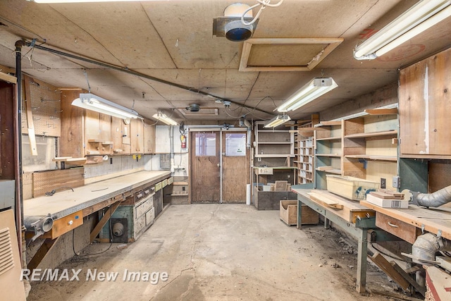 interior space with a workshop area and unfinished concrete flooring