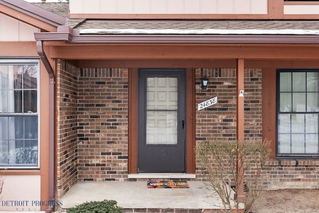 view of exterior entry with brick siding