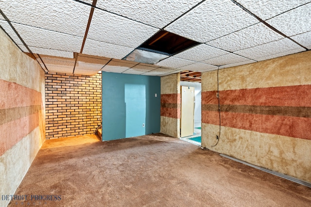 carpeted spare room featuring a paneled ceiling