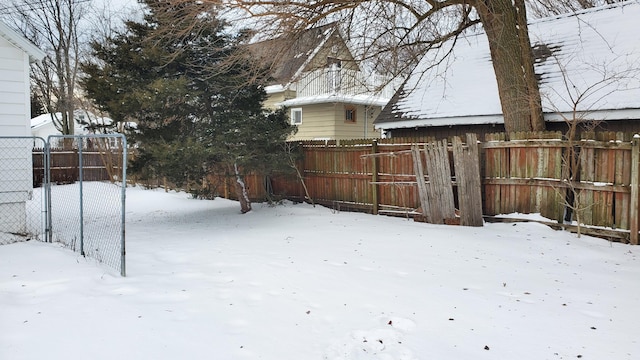 snowy yard with fence