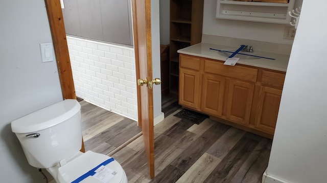 bathroom featuring vanity, wood finished floors, and toilet