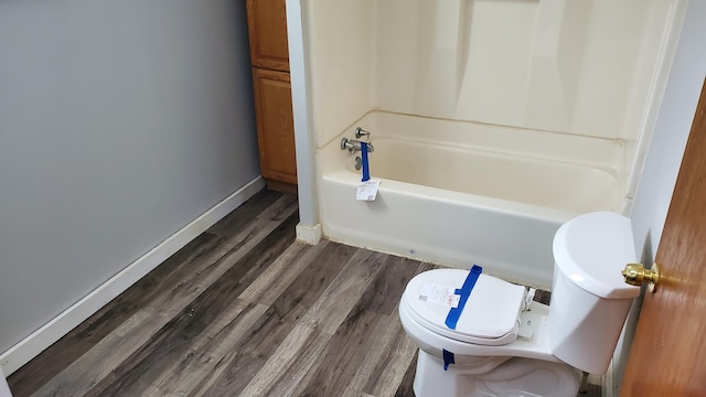 full bath with toilet, baseboards, and wood finished floors