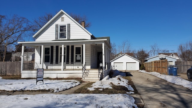 view of front facade with covered porch, a garage, an outdoor structure, fence, and a chimney