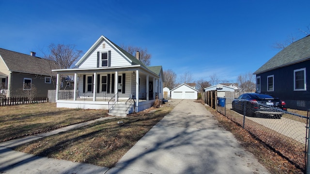 view of front of property featuring a chimney, a detached garage, fence, an outdoor structure, and a porch