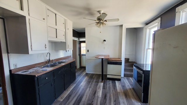 kitchen with ceiling fan, white appliances, a sink, white cabinetry, and dark wood-style floors