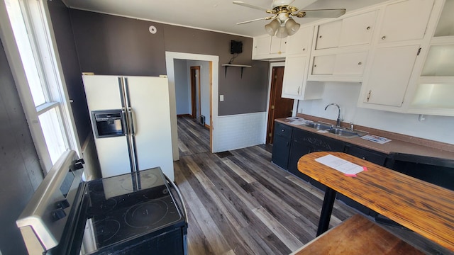 kitchen featuring dark wood-style floors, electric range, white cabinets, a sink, and white fridge with ice dispenser