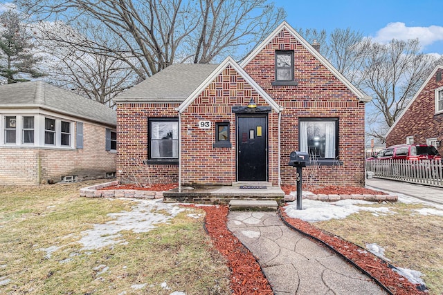 view of front facade with a front yard and brick siding