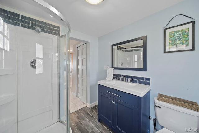 full bath featuring tasteful backsplash, wood tiled floor, a shower stall, and vanity