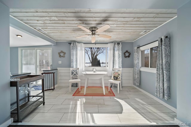 dining area with baseboards and a ceiling fan