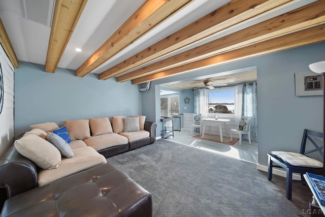 carpeted living area featuring beamed ceiling and baseboards