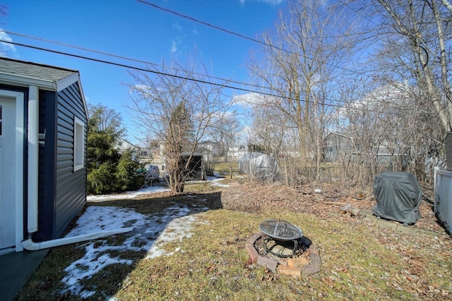 view of yard with an outdoor fire pit and fence