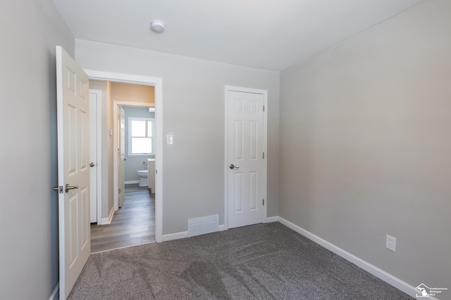 unfurnished bedroom with baseboards, visible vents, and carpet flooring