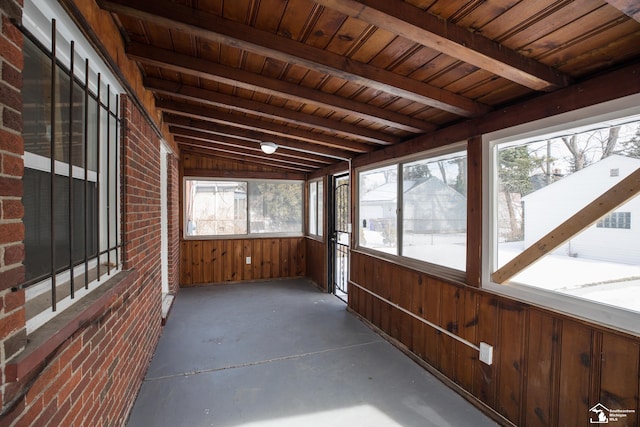 unfurnished sunroom with wood ceiling and beam ceiling