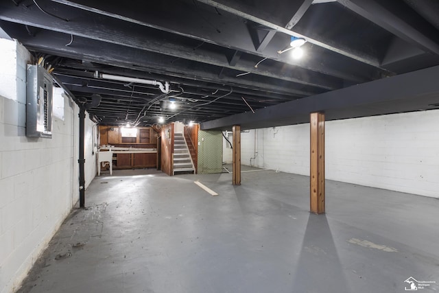 basement with stairway and electric panel