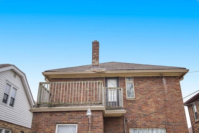 16636 Sorrento St, Detroit, MI 48235 - rear view of house with brick siding, a chimney, and roof with shingles