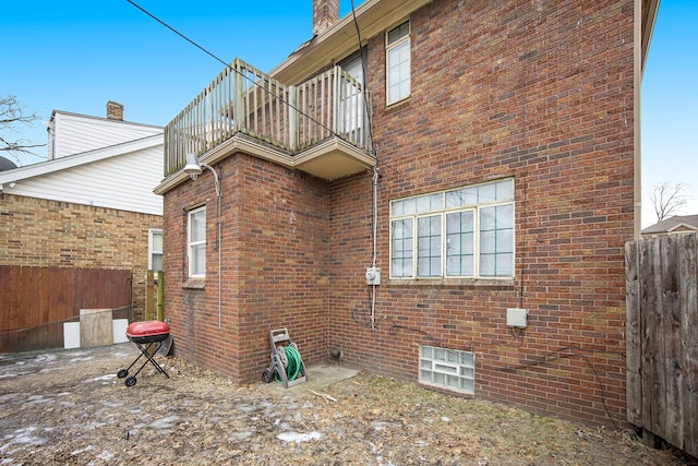 16636 Sorrento St, Detroit, MI 48235 - view of property exterior with brick siding, a balcony, and fence