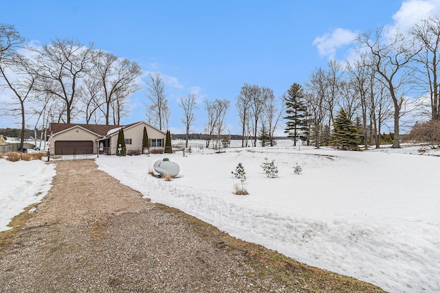 yard covered in snow with an attached garage