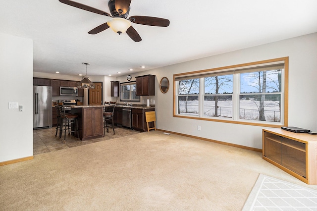 living room with light carpet, baseboards, and recessed lighting