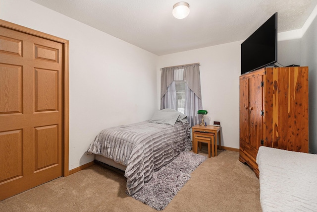 bedroom featuring carpet and baseboards