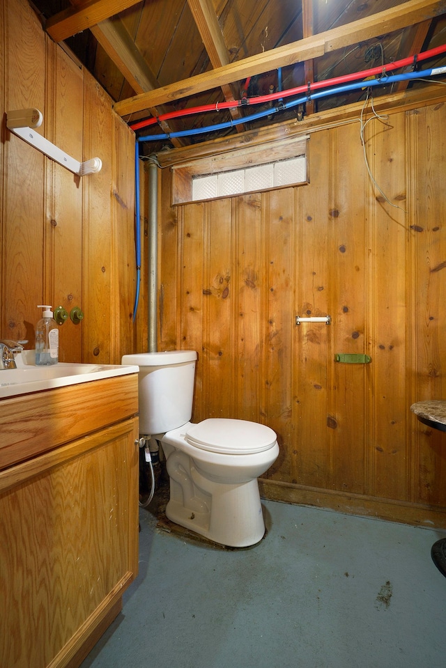 14927 Fairmount Dr, Detroit, MI 48205 - bathroom featuring vanity, wooden walls, toilet, and concrete flooring