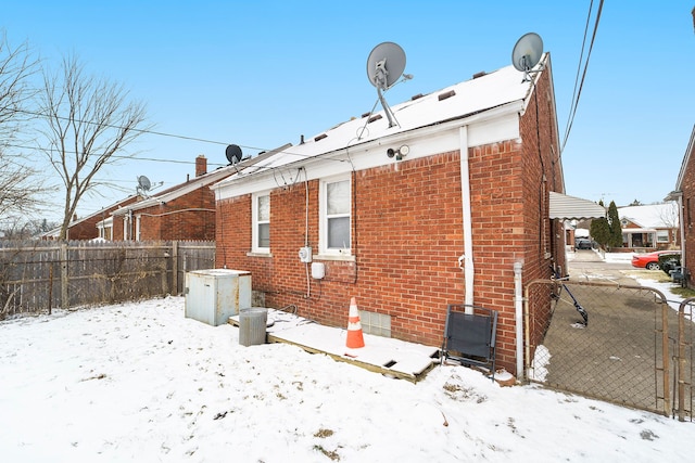 14927 Fairmount Dr, Detroit, MI 48205 - snow covered property featuring fence and brick siding