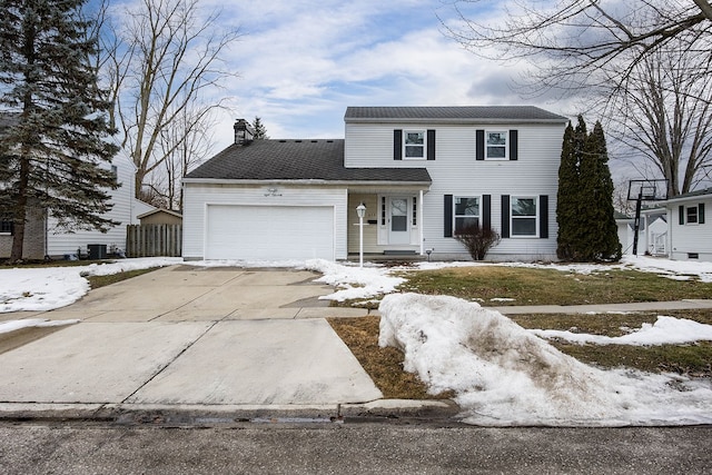 traditional-style house with a garage, driveway, a chimney, and fence