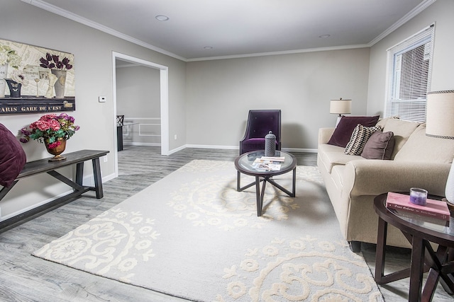 living room with ornamental molding, baseboards, and wood finished floors