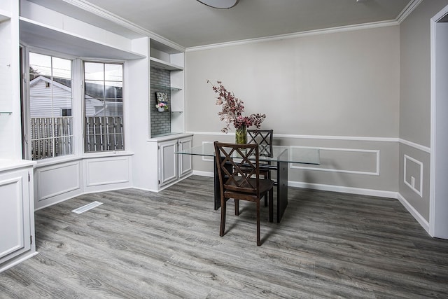 dining room with ornamental molding and wood finished floors